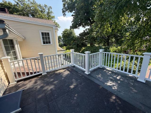 Elevated deck with white railings at dusk