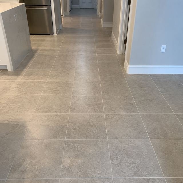 Tile flooring installation in a kitchen hallway